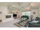 Inviting living room with fireplace, built-in shelving, and cozy seating at 120 Fernbrook Rd, Oldsmar, FL 34677