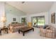 Bright living room featuring neutral paint, large mirror wall and sliding glass doors at 120 Fernbrook Rd, Oldsmar, FL 34677