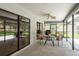 A cozy, covered patio features a ceiling fan and seating area, perfect for relaxing outdoors at 120 Fernbrook Rd, Oldsmar, FL 34677