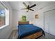 Bedroom with wood-look flooring, ceiling fan, and a window providing natural light at 12304 Woodleigh Ave, Tampa, FL 33612