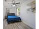 Cozy bedroom with wood-look flooring and a comfortable bed with nice wall art at 12304 Woodleigh Ave, Tampa, FL 33612