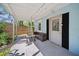 Inviting entryway with outdoor seating and a view of the fenced yard at 12304 Woodleigh Ave, Tampa, FL 33612