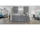 Modern kitchen with gray cabinets, granite countertops, and stainless steel appliances at 12304 Woodleigh Ave, Tampa, FL 33612