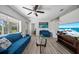 Bright living room featuring stylish furniture, a ceiling fan, and a large TV at 12304 Woodleigh Ave, Tampa, FL 33612