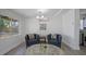 Bright living room featuring comfortable seating, modern lighting, and a large window at 12304 Woodleigh Ave, Tampa, FL 33612
