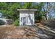 Modern shed with a deck, surrounded by lush greenery, offering a peaceful retreat or storage space at 12304 Woodleigh Ave, Tampa, FL 33612