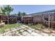 Image of the fenced in backyard area with overgrown yard at 1242 Bermuda St, Clearwater, FL 33755