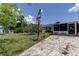 View of the backyard with paver patio area that leads to the screened in lanai at 1242 Bermuda St, Clearwater, FL 33755