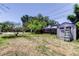 Spacious backyard featuring a shed, offering ample storage and outdoor possibilities at 1242 Bermuda St, Clearwater, FL 33755