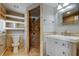 Bathroom featuring a mosaic tiled shower, single sink vanity, and a separate toilet area at 1242 Bermuda St, Clearwater, FL 33755