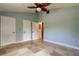 Bright bedroom with fan, tile floors, and two closets for storage at 1242 Bermuda St, Clearwater, FL 33755