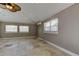 Bedroom featuring a ceiling fan, tile flooring, and two windows with natural light at 1242 Bermuda St, Clearwater, FL 33755