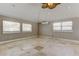 Bedroom featuring three windows for ample natural light, tile flooring, and a ceiling fan at 1242 Bermuda St, Clearwater, FL 33755