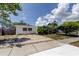 Inviting single-story home featuring a spacious driveway and lush landscaping in a peaceful setting at 1242 Bermuda St, Clearwater, FL 33755