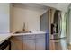 A partially renovated kitchen features stainless steel appliances and painted cabinets at 1242 Bermuda St, Clearwater, FL 33755