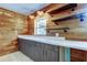 A kitchen with wood paneled walls, floating shelves, and ample countertop space at 1242 Bermuda St, Clearwater, FL 33755