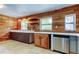 A partially renovated kitchen with wood paneled walls and ample countertop space at 1242 Bermuda St, Clearwater, FL 33755
