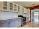 A partially renovated kitchen featuring wood-paneled walls and stainless steel appliances at 1242 Bermuda St, Clearwater, FL 33755
