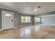 Spacious living area with neutral color palette, tile flooring, and a front door entrance for an open and welcoming feel at 1242 Bermuda St, Clearwater, FL 33755