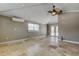 Living room with fan, tile flooring, two windows, and french doors at 1242 Bermuda St, Clearwater, FL 33755