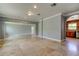 Expansive living room features tile flooring, neutral decor, and an arched entry for seamless flow into other areas at 1242 Bermuda St, Clearwater, FL 33755
