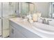 Updated bathroom features double sinks, quartz countertops, and a glass-enclosed shower at 12435 Gust Ct, Hudson, FL 34669