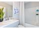 Bright bathroom featuring a shower-tub combination, modern fixtures, and fresh gray paint at 12435 Gust Ct, Hudson, FL 34669