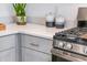 Well-equipped kitchen with modern countertops, stainless steel gas range, and gray cabinets at 12435 Gust Ct, Hudson, FL 34669