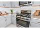 Stylish kitchen featuring stainless steel appliances, quartz countertops, and sleek cabinetry at 12435 Gust Ct, Hudson, FL 34669