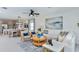 Open-concept living room with dining area features designer finishes and abundant natural light at 12435 Gust Ct, Hudson, FL 34669