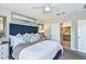 Comfortable main bedroom features stylish decor and a glimpse into the en-suite bathroom at 12435 Gust Ct, Hudson, FL 34669