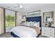 Serene main bedroom with a luxurious headboard, soft lighting, and a large window overlooking the greenery at 12435 Gust Ct, Hudson, FL 34669