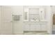 Modern bathroom with double sink vanity, neutral walls, new cabinets, and white painted doors at 12597 Lily Quartz Loop, Parrish, FL 34219