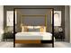 A cozy bedroom featuring a four-poster bed, bedside tables, lamps, neutral walls and carpet at 12597 Lily Quartz Loop, Parrish, FL 34219
