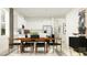 Bright dining area adjacent to a modern kitchen with white cabinetry and stainless steel appliances at 12597 Lily Quartz Loop, Parrish, FL 34219