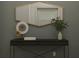 Stylish entryway featuring a sleek console table, decorative mirror, and modern accents at 12597 Lily Quartz Loop, Parrish, FL 34219