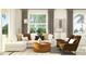 Inviting living room with a comfortable sectional sofa, stylish decor, and large windows at 12597 Lily Quartz Loop, Parrish, FL 34219