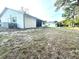 Exterior backyard featuring a partial fence and exterior building with white siding at 13100 Serpentine Dr, Hudson, FL 34667