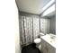 Well-maintained bathroom with vanity, mirror, and shower with patterned curtain at 13100 Serpentine Dr, Hudson, FL 34667