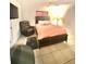 Comfortable bedroom with TV, cozy armchair, and ample space for relaxation and enjoyment at 13100 Serpentine Dr, Hudson, FL 34667