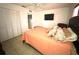 Relaxing bedroom with plush bed, TV, and closet at 13100 Serpentine Dr, Hudson, FL 34667