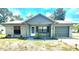 Charming single-story home featuring a well-maintained lawn, attached garage, and inviting front entrance at 13100 Serpentine Dr, Hudson, FL 34667