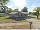 Charming single-story home with gray siding, attached garage, and well-manicured lawn at 13100 Serpentine Dr, Hudson, FL 34667