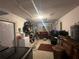 View of the garage space with garage door, white walls, and ceiling access panel at 13100 Serpentine Dr, Hudson, FL 34667