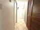 Bright hallway with tile flooring, closet and access to various rooms within the home at 13100 Serpentine Dr, Hudson, FL 34667