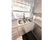 Kitchen sink featuring a double basin, modern faucet, tiled backsplash, and view of the outdoors at 13100 Serpentine Dr, Hudson, FL 34667