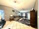 Living room featuring a vaulted ceiling, stylish furnishings, and neutral tile flooring at 13100 Serpentine Dr, Hudson, FL 34667