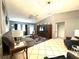 Bright living room with a gray sectional, entertainment center, and neutral tile flooring at 13100 Serpentine Dr, Hudson, FL 34667