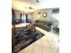 Living room with a large gray sofa, accent rug, tile floor, and stylish decor at 13100 Serpentine Dr, Hudson, FL 34667