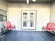 Charming covered patio with cozy seating, perfect for outdoor relaxation and enjoyment at 13100 Serpentine Dr, Hudson, FL 34667
